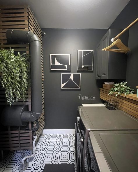 Incredible transformation in just two days! The decision to paint the walls ‘Iron Ore’ from @sherwinwilliams was spot on—it adds a dramatic and modern vibe. The sleek wood slat panel is a perfect way to hide the washer and dryer hookups, and it complements the bold geometric flooring perfectly. This laundry room makeover is seriously one of my favorites. #LaundryRoomMakeover #HomeTransformation #IronOre #SherwinWilliams #ModernDesign #DIYHome #InteriorInspo #LaundryRoomGoals #furnitureartis... Black Accent Laundry Room, Laundry Room Workout Room Combo, Hgtv Design, Grey Laundry Rooms, Hgtv Designers, Geometric Floor, Iron Ore, Grey Flooring, Laundry Room Makeover