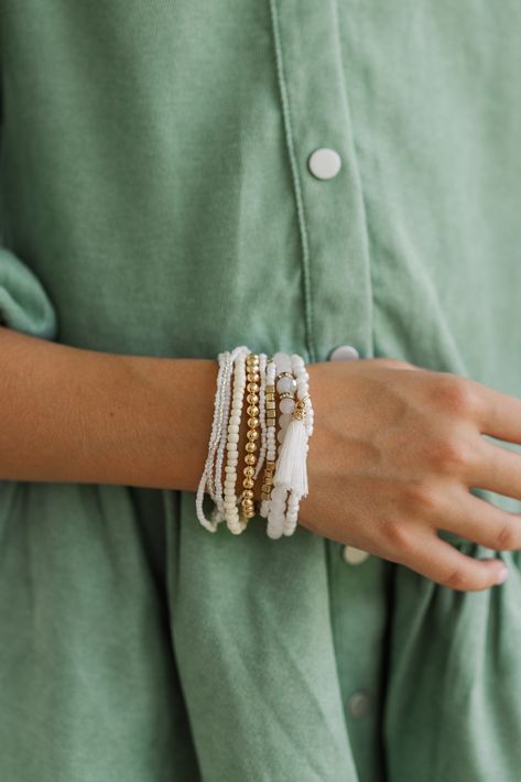 How much fun is this bracelet set?! All of those beads look so good together and we love the pops of gold! Plus, those varying little charms are so cute! Handmade Cream Beaded Bracelets, Casual Gold Beaded Charm Bracelet, Casual Gold Stackable Friendship Bracelets, White Jewelry With Gold Beads For Friendship, Trendy White Jewelry With Gold Beads, Casual Everyday Jewelry With Gold Beads, Casual Gold Friendship Bracelets With Gold Beads, Casual Gold Beaded Jewelry For Everyday Use, Casual Gold Beads Jewelry For Everyday