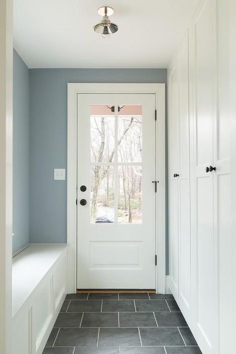 White, blue and gray mudroom finished with slate floor tiles and white grout. Gray Mudroom, Dark Stained Wood Floors, Mudroom Paint Color, Grey Hallway, Mudroom Remodel, Blue Laundry Rooms, Built In Lockers, Slate Floor, White Grout