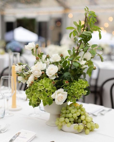 WILD FLOS on Instagram: "🍇 Stylist @weddingsofdesire Photographer @louisetreacyphotography" Fruit In Flower Arrangements, Cocktail Table Flower Arrangements, White Green Wedding Decor, Garden Style Centerpieces, Fruit Flower Arrangements, Green Wedding Arrangements, Fruit Wedding Decor, Fruit Centerpieces Wedding, Wedding Table Flower Arrangements