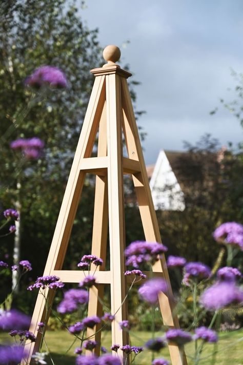 Our wooden obelisks can provide year round structure in your garden, even when the planting dies back. Browse the range on the website toda. #gardentrellisco﻿ #obelisk #gardenjoinery #plantsupport #obelisks #gardenstructure #gardenarchitecture #joinery #garden #gardening #outdoordesign #landscape #gardendesign #gardendesignideas Wooden Obelisk, Garden Architecture, Open Frame, Plant Supports, Garden Features, Garden Trellis, Climbing Plants, Garden Structures, Outdoor Design