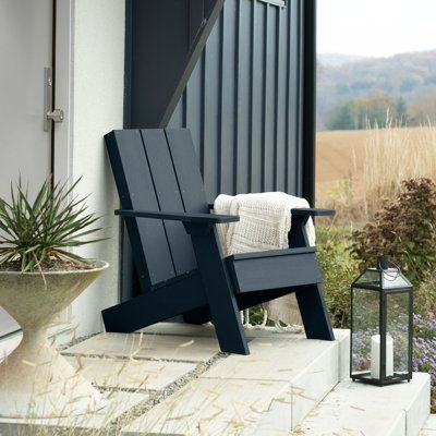 Create a new focal point in your outdoor space with this Adirondack chair. Three oversized back slats put a contemporary spin on what is truly an American classic, the Adirondack chair. Wide arms and legs combine maximum comfort with modern beauty. Pair with the Byrnes modern side table for a fresh take on a traditional backyard favourite or explore the entire line of products to coordinate other beautiful, durable products that will make your outdoor living space the envy of the neighbourhood. Modern Front Porch Chairs, City Balcony, Modern Front Porches, Backyard Dining, Modern Adirondack Chair, Modern Outdoor Chairs, Cottage Porch, Modern Adirondack, Porch Chairs