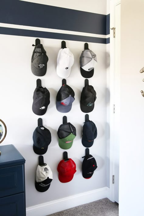 Learn the simple way to make an organized hat wall so you can have easy access to all of your hats any time you need them! #hatwall #hatorganization #organizedhats Boys Room Hat Storage, Cap Hanging Ideas, Hat Display Ideas Wall, Hat Hanging Ideas, Baseball Cap Storage Ideas, Boys Room Organization Ideas, Boys Room Organization, Smart Kids Room, Boys Bedroom Organization