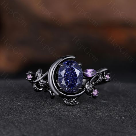 Blue Sandstone Engagement Ring, Unique Ring for Her, Gothic Black Gold Ring for Women, Moon Style Weeding Ring Main Stone: 6x8mm Oval Cut Blue Sandstone. Side Stone: Amethyst Band Width: Approx. 1.6mm Our Services: All sizes are available, if you need other ring sizes, please feel free to contact me. Production Time: Since all rings are handmade according to orders, it takes about 13-15 working days (excluding weekends) to make, and 3-5 working days to arrive, thank you for your understanding. Expedited Order: We provide expedited order service, it takes about 7-10 working days (excluding weekends) to complete the ring, and 3-5 working days to arrive, if you are in a hurry to get the ring, please contact me. Payment Plan: We offer payment plan, you can pay weekly or monthly, we will keep t Engagement Ring Star, Engagement Rings Unique Non Traditional, Acotar Engagement Ring, Engagement Rings Moon, Celestial Oval Sapphire Ring Gift, Fairy Engagement Rings, Ring Designs Engagement, Celestial Moon-shaped Moonstone Wedding Ring, Blue Celestial Rings With Accent Stones