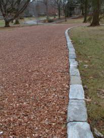 pea gravel with stone border | The granite cobblestone edging adds a distinctive look and keeps the ... Cobble Edging, Driveway Update, Cobblestone Edging, Tar And Chip Driveway, Gravel Driveway Edging, Granite Cobblestone, Raised Borders, Driveway Border, Gravel Drive