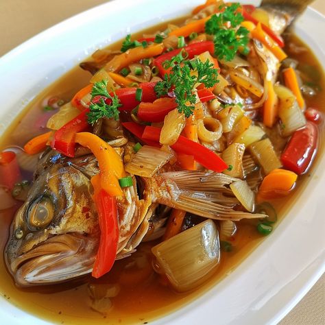 🐟 Enjoy the vibrant taste of Escabeche! 🍋✨ #SweetAndSourFish #FilipinoCuisine Escabeche (Sweet and Sour Fish) Ingredients: Whole fish (1 kg) Carrot, julienned (1) Red bell pepper, julienned (1) Onion, sliced (1) Garlic, minced (3 cloves) Ginger, julienned (1 tbsp) Vinegar (1/2 cup) Sugar (1/4 cup) Soy sauce (2 tbsp) Cornstarch (1 tbsp, dissolved in water) Salt and pepper to taste Oil (for frying) Instructions: Fry the whole fish until golden brown. Set aside. Sauté garlic, ginger, and oni... Sweet And Sour Fish, Whole Fish, Instagram Recipes, Twisted Recipes, Trending Recipes, Frying Oil, Sweet And Sour, Red Bell Pepper, Fried Fish