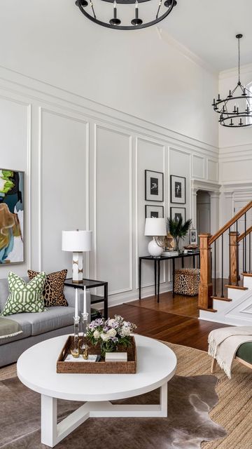 Erika Ward Interiors on Instagram: "Tall ceilings can be intimidating if you’ve got a big blank wall staring you in the face. We transformed this room with stunning trim moldings! 🌟 These timeless details elevate any room, adding classic elegance and boosting your home’s resale value. Invest in style that lasts! 🏡✨ #HomeDecor #TimelessDesign #TrimMoldings #HomeImprovement #ErikaWardInteriors" Wall Molding Cathedral Ceiling, Wainscoting Ideas Living Room High Ceiling, High Ceiling Wall Paneling, Wall Molding On Angled Wall, Tall Wall Moulding Ideas, Wall Panelling High Ceiling, Wall Molding Tall Ceilings, Wall Paneling Tall Ceiling, High Ceiling Entry Way Wall Decor