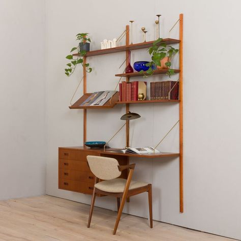 Danish wall unit in the style of Preben Sorensen comes from the 1960s. This entirely modular shelving system is ideal for a home office, as the compact desk will allow you to work in the living room. The set is finished in teak veneer with solid teak carpentry details and rails. The set consists of:  - 4 shelves 20 cm deep,  - a desk-shelf 45 cm deep,  - expository shelf 32 cm deep  - a chest with 4drawers  H:50 /W:80 /D: 40 cm, drawers height: 9 cm  - 3 wooden wall rails, each 200 cm long,  - b Office Shelves Styling, Modern Shelf Styling, Wall Shelf Desk, Danish Home Decor, Carpentry Details, Office Wall Shelves, Floating Wall Unit, Mid Century Shelving, Teak Bedroom