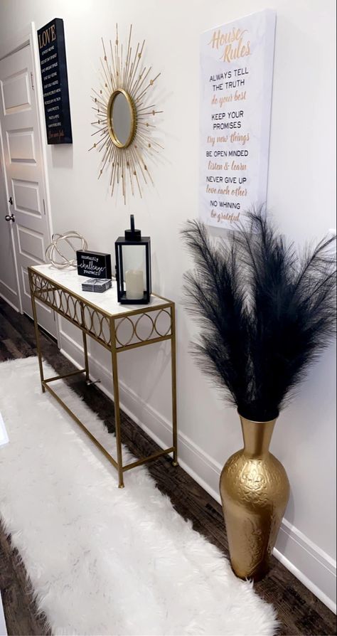 Edgy Chic Home Decor, Vase With Feathers Decor, Aesthetic Hallway Ideas, Glass Entryway Table Decor, Cream House Decor, Black White And Gold House Aesthetic, Living Room Decor For Apartments, Apartment Stairway Decorating, Black And Gold Apartment Decor