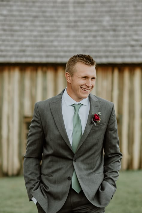 Gray Suit Sage Tie, Grey Green Tuxedo Wedding, Charcoal Grey Suit Sage Green Tie, Grey Tux With Green Tie, Dark Grey And Sage Wedding, Groomens Attire Sage Green, Charcoal Grey And Sage Green Wedding, Gray Suit With Sage Green Tie, Dark Sage Suit