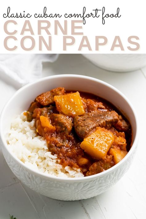 A white bowl of cuban beef stew on white rice with the words "classic cuban comfort food Carne con Papas" in the foreground Carne Con Papas Cuban Instant Pot, Carne Con Papas Cuban Crockpot, Stew Meat Recipes Mexican, Cuban Pork Stew, Cuban Beef Recipes, Cuban Pork Chunks, Boneless Pork Stew Meat Recipes, Beef Chunks, Carne Con Papas Cuban