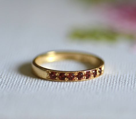 Romantic half eternity garnet ring, dainty stacked gemstone ring, Feminine minimalist jewelry for women, available in high quality 14k gold plating, sterling silver, 9k solid yellow gold, or 14k solid yellow, rose, or white gold.    This handmade band is delicate and elegant. The ring is set with 7 beautiful deep red garnets, January's birthstone.  It is available in nickel-free 14k gold plating over brass or over silver, sterling silver, 9k solid yellow gold, or 14k solid yellow, rose, or white Garnet Band Ring, Dainty Gold Promise Ring, Gemstone Ring Stack, Garnet Wedding Band, Gold Ring Bands For Women, Garnet Gold Ring, Classic Garnet Ring Jewelry, Fine Jewelry Gold Garnet Rings, Red Ring