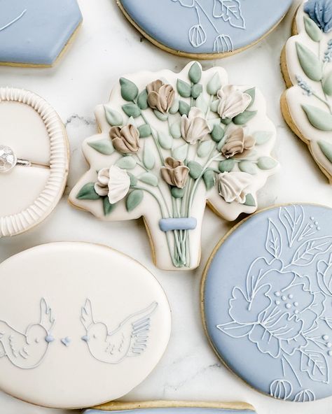 This sweet bridal shower set was winning the polls, so here’s the full set! Swipe to see closeups, including their sweet pups!. My favorite are the simple cookies with the tiny line details. The blue with the white floral, leaf cookie, and the birds were from her invitation! I love this elegant, minimalist, and floral set! . #weddingcookies #bridalshowercookies #bridecookies #floralcookies #flowercookies #somethingbluebridal #bluewedding #springcookies #engagementcookies #ringcookies #dogcoo... Bride Cookies, Flower Sugar Cookies, Engagement Cookies, Bridal Shower Desserts, Wedding Doves, Royal Icing Sugar, Garden Bridal Showers, Leaf Cookies, Simple Cookies