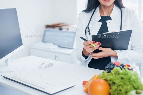 Female nutritionist in white coat sitting indoors in the office at workplace by mstandret. Female nutritionist in white coat sitting indoors in the office at workplace. #Sponsored #white, #coat, #Female, #nutritionist Nutritionist Office, Nutritionist Branding, Dietetics Student, Medical School Inspiration, Business Photoshoot, Editorial Inspiration, Trifold Brochure Template, Graduation Photography, Future Jobs