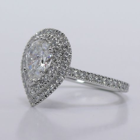 The Pear-Cut Diamond is encircled by a double halo of pave diamonds, which make the stone appear a lot larger in size. Diamond Ring With Halo, Ruby Engagement Ring Vintage, Rose Gold Emerald Ring, Double Halo Diamond Engagement Ring, Cushion Moissanite Engagement Ring, Ring With Halo, Branch Engagement Ring, Vintage Engagement Rings Art Deco, Pear Shaped Diamond Ring