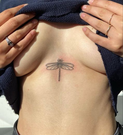 Dragon Fly Tattoo Sternum, Dragon Fly Sternum Tattoo Women, Dragon Fly Chest Tattoo, Hideable Tattoos Placement, Dragon Tattoo Under Breast, Small Insect Tattoo, Tattoo Around Arm, Egg Tattoo, Dragon Fly Tattoo