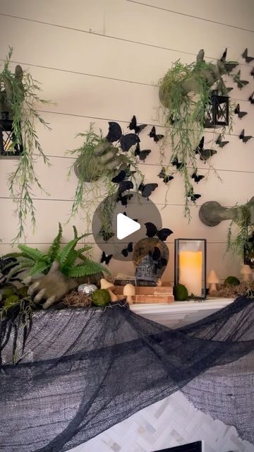 Mariah Leeson on Instagram: "Nature meets creepy as gnarled hands claw through the wall and set the macabre mood for this elegant yet eerie Haunted Garden Halloween Mantel. 

These creepy arms from Oriental Trading are the focal point of this year’s Halloween decorations, and I am obsessed!  Cascading vines and moss give the impression of a once-vibrant garden overtaken by time and ghosts. A swarm of black butterflies flutter above moss and garden vines, skulls lay covered in moss, and lanterns flicker bringing the outdoors inside, merging the beauty of nature with the haunting allure of Halloween.

Ready to get your spooky on?  @orientaltrading is your Halloween headquarters, with everything you need to create an eerie display.  Use code YAY for free shipping on all orders. #otcpartner #o Decorating With Moss, Haunted Garden, Black Butterflies, Halloween Mantel, Garden Vines, Outdoors Inside, The Haunting, Black Butterfly, Focal Point