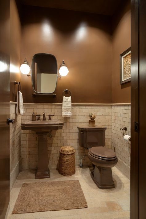 A small brown half bathroom with a warm, rustic feel enhanced by earthy tones and vintage elements. Brown Wall Bathroom Ideas, Single Toilet Room, Small Brown Bathroom Ideas, Small Half Bathroom Design, Tiny Half Bathroom Ideas, Bar Bathroom Ideas, Small Half Bathroom Ideas, Half Bathroom Design Ideas, Half Bathroom Design