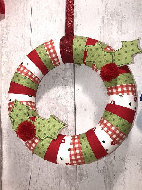 Create a Pretty Wreath from Fabric Strips - Quilting Digest Quilted Wreath, Fabric Wreaths, Christmas Fabric Crafts Wreaths & Garlands, Plaited Fabric Christmas Wreath, Sewnfabric Wreath, Swen Fabric Wreath, Quilted Christmas Ornaments Wreaths & Garlands, Homemade Christmas Wreaths, Christmas Bunting