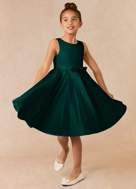 Complete your bridal party with our clean modern Matte Satin flower girl dress, Coco. Her scoop neckline is complimented by a belt with a bow at the front. The skirt is pleated beautifully to flare as she walks down the aisle. Emerald Green Dress For A Wedding Bridesmaid For Kids, Emerald Green Flower Boy, Flower Girl Green Dresses, Green Dress For Kids, Flower Girl Dresses Emerald Green, Flower Girl Dresses Green, Emerald Wedding Flower Girl, Dark Green Flower Girl Dresses, Flowergirls Dress Green