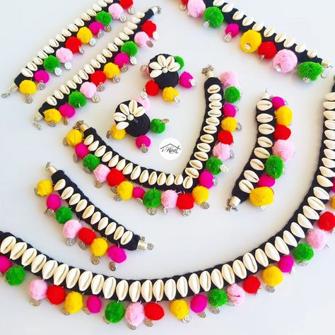 Are you planning for your navratri look in advance but haven't finalized the Jewellery yet? Checkout this beautiful Multicolored jewellery set adorned with lots of Cowrie shells, coins and pom poms to match your Garba Vibes for this Navratri Season 🔥 Items included: ❤️ Necklace ❤️ Jhumka ❤️ Headband ❤️ 2 Bracelets ❤️ Anklets ❤️ Waist belt Visit indiashaat.com for more handmade jewellery options #indiashaat #navratrijewellery #bohojewellery #multicolourjewellery #dakla2 [Handmade ... Navratri Vibes, Navratri Look, Navratri Jewellery, Colorful Rangoli, Fabric Jewellery, Colorful Rangoli Designs, Cowrie Shells, Cowrie Shell, Jewellery Set