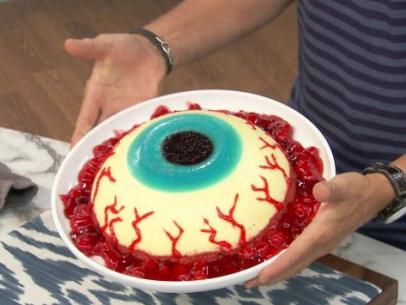 Eyeball Cake Recipe | Food Network Eyeball Cheesecake, Eyeball Cake, Chocolate Dirt, Creepy Halloween Party, Cheesecake Mix, Leftover Candy, Black Food Coloring, Pumpkin Ice Cream, Spooky Food