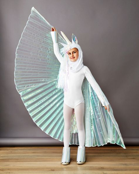 Pegasus-Unicorn Costume | An iridescent fringed party curtain, glittery fabric, pleated dancer's cape, and an LED candle are all it take to create this magical kid's Halloween costume. Click here for the full instructions.  #halloween #DIYcostumes #marthastewart #kidscostumes Diy Fantasia, Sew Halloween Costume, Most Popular Halloween Costumes, Unicorn Halloween Costume, Popular Halloween Costumes, Pegasus Unicorn, Cape Costume, Valentine's Ideas, Diy Kostüm