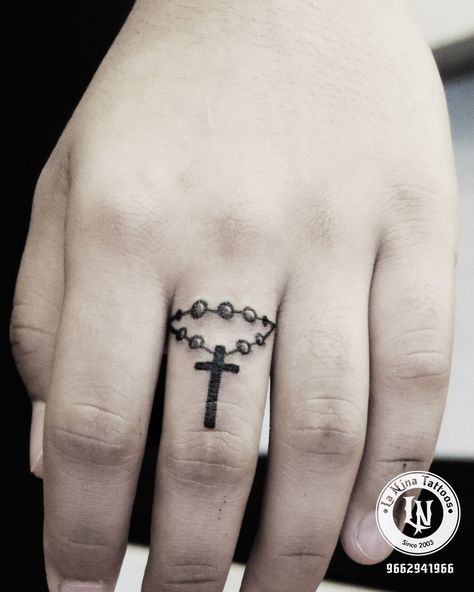 Finger tattoo done at La nina tattoo studio #laninatattoos #tattoo #cross #fingertattoo#besttattoo#ahmedabad #gujarat #india Cross Pendant Hand Tattoo, Finger Cross Tattoo, Nina Tattoo, Female Tattoo Artist, Wrist Band Tattoo, Cute Ankle Tattoos, Tattoo Cross, Catholic Tattoos, Rosary Tattoo