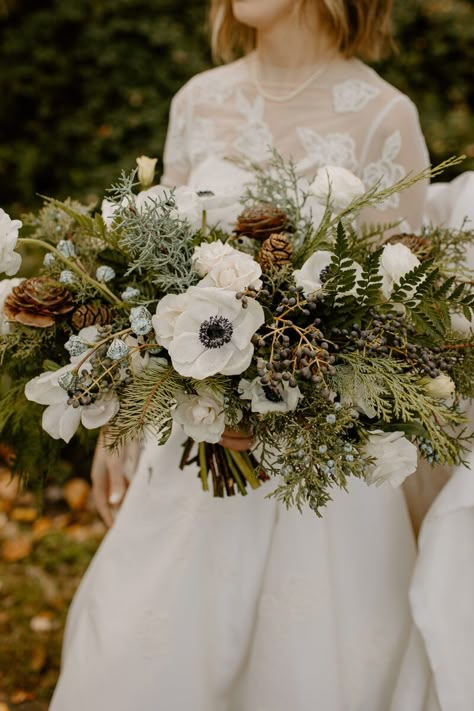 An Evergreen Winter Wedding At Axis Pioneer Square - Flora Nova Design - Premier Event Design Studio in Seattle Bridal Bouquet With Pinecones, Evergreen Bridal Bouquet, Pinecone Wedding Bouquet, Christmas Bouquet Wedding, Juniper Bouquet, December Wedding Bouquets, December Wedding Flowers, Forest Wedding Bouquet, Christmas Bridal Bouquet