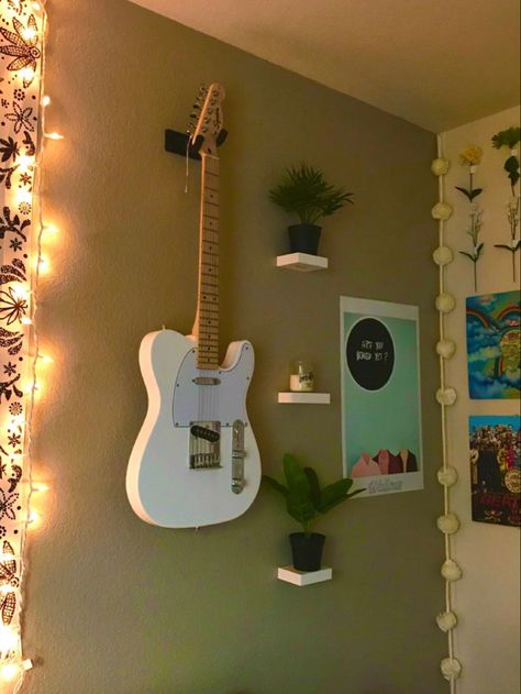 Indie wall guitar wall leaves and flower wall aesthetic cute Guitar Wall Mount Aesthetic, Room Guitar Aesthetic, Wall Mounted Guitar Ideas, Guitar Mounted On Wall Decor, Guitar Hanging Ideas Bedroom, Guitar Wall Display Bedroom, Hanging Guitars On Wall Ideas Bedroom, Bedroom Guitar Setup, Guitar Themed Bedroom