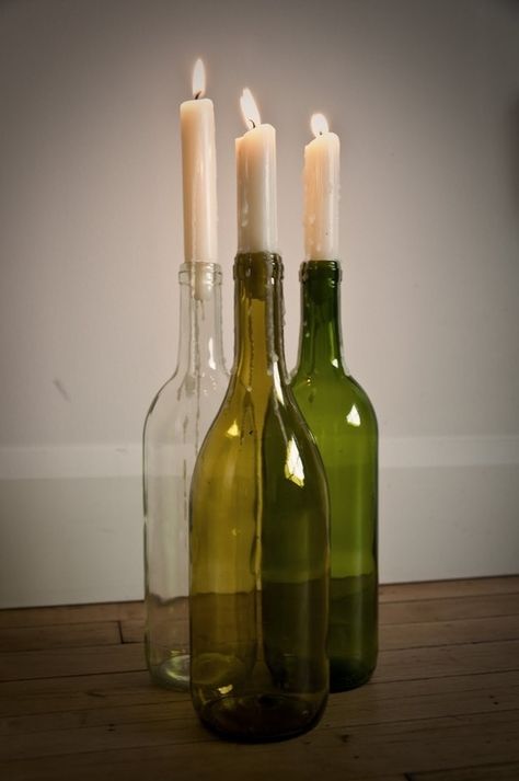 Again: You have wine. You have candles. Voilá, you have art. | 22 DIY Ways To Reuse Empty Booze Bottles Glass Bottle Candle Holder Diy, Candlestick Wine Bottle, Wine Bottle With Candle, Wine Candle Holders, Wine Bottle Candle Holders Diy, Bottle Candles Diy, Diy Wine Bottle Decor, Wine Bottle Candle Holders, Upcycle Wedding