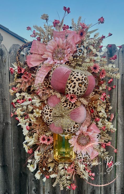 The total dimensions are 38" long and 22" wide. Two blinged out pumpkins with leopard print. Also has large gemstone. Nice big bow Keeping the wreath from direct sunlight and harsh weather will keep it from fading and wear.  A direct overhang, awning or patio is ideal. This wreath is made on a wire ring base with high quality florals and wired ribbons. Keep the original shipping box as this is the perfect size box for storing your custom design.  A quick fluff of the ribbons and it is ready to display next season.  All my wreaths are available for shipping out ASAP, my shipping boxes are quality boxes that you can keep store your wreath in after the season is over.  Each wreath is handcrafted with love by myself! They boast so many details including unique ribbons, colorful tool, fun and c Pink Door Decor, Babam Wreaths, Purple Swag, Bows Wreaths, Pink Fall, Fall Designs, Christmas Swag, Fall Stuff, Pink Door