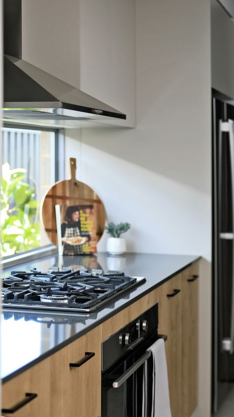 Step into a modern industrial kitchen that exudes sleek sophistication. Featuring a striking black benchtop and a splashback window that brightens the space, this kitchen combines bold design with practical elegance. Let Easystart Homes bring this contemporary industrial vision to life in your new home. Black Benchtop Kitchen, Black Benchtop, Modern Industrial Kitchen, Modern Industrial Design, Industrial Kitchen, Super Flexible, Bold Design, Modern Industrial, Industrial Design