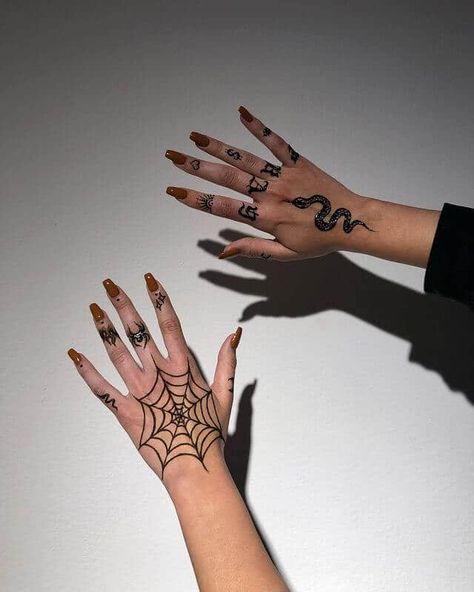 20 Interesting Hand Tattoos For Women You'll Be Obsessed With Spider Hanging From Web Tattoo Design, Goth Hand Tattoos For Women, Spider Web Tattoo On Hand, Cobweb Hand Tattoo, Skeleton Hand Spider Web Tattoo, Halloween Hand Tattoos For Women, Gothic Hand Tattoos For Women, Spider Web Finger Tattoo, Web Tattoo Hand