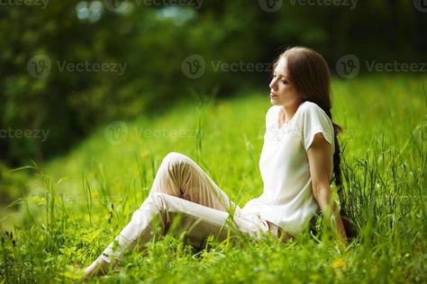 Pensive woman sitting on the grass Sitting In Grass Poses, Rock Poses, Sitting In Garden, Someone Sitting, Sitting On Floor, Grassy Hill, Space Man, Grassy Field, Grass Field