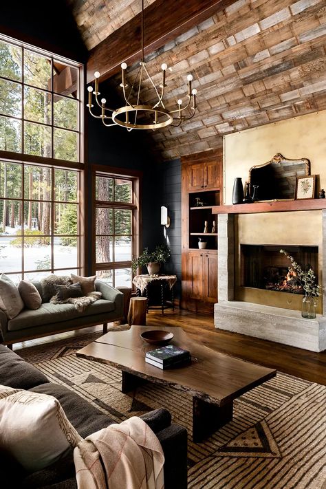 Soaring, barn-wood–clad ceilings and massive windows meet dark, moody colors for a cocoon-like feel in this Lake Tahoe cabin. Hunting Cabin Interior Living Room, Lake Tahoe Homes Interior, Moody Log Cabin Interior, Dark Moody Cabin Interior, Dark California Cool Interior, Wooden Cabin Interior Design, Dark Cozy Cabin Interior, Relaxed Elegance Interior Design, Moody Mountain Living Room