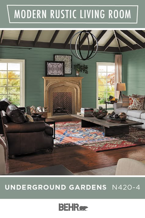 Rustic interior design gets a colorful twist thanks to BEHR® Paint in Underground Gardens. This rich green hue ties together this entire living room. Paired with leather couches, dark wood floors, an exposed beam ceiling, and overlapping rugs, it’s the perfect look. Click below to learn more. Underground Gardens Behr Paint, Rustic Paint Colors, Apple Hill, Rustic Interior Design, Behr Paint Colors, Painted Pot, Modern Rustic Living Room, Farmhouse Paint, Behr Paint