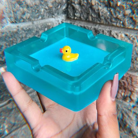 bath duck ashtray 🐥🫧   Discover the perfect blend of functionality and art with our handcrafted resin ashtrays. Each piece is meticulously made, offering a unique design that adds a touch of elegance to any space. Ideal for both smokers and decor enthusiasts. #Handcrafted #ResinArt #UniqueDesign #StylishHome #AshtrayArt #HomeDecor #HandmadeCrafts #ArtisanMade #FunctionalArt #DecorInspiration#duck #bathduck #whattheduck #ducklife Resin Ashtray Ideas, Epoxy Ashtray, Vintage Desserts, Bath Duck, Hot Glue Art, Resin Ashtray, Glue Art, Vintage Dessert, Resin Artwork