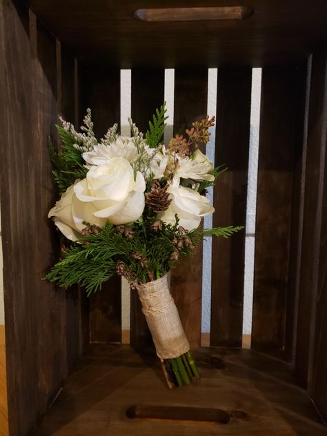 Pine Cone Bridal Bouquet, Evergreen Bridesmaid Bouquet, White Rose Pine Cone Bouquet, Winter Wedding Flowers Bridesmaid, January Wedding Bouquet Winter Flowers, White Roses And Pine Cones, Winter Wedding Bridesmaids Bouquets, Bridesmaid Bouquet Winter Wedding, Bridal Bouquet Winter Simple