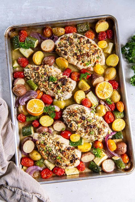 Feta stuffed boneless chicken breasts roast on a baking sheet along with colorful vegetables and halved lemons for this Greek Sheet Pan Chicken. Fresh, easy, and loaded with Greek flavor! #chickendinner #chickenrecipes #greekfood #sheetpanmeals Greek Sheet Pan Chicken Dinner, Greek Chicken Best Sheet Pan Dinner, Sheet Pan Spinach Herb Baked Chicken, Greek Chicken And Veggies Sheet Pan, Sheet Pan Mediterranean Chicken Brussel Sprouts And Gnocchi, Lemon Feta Sheet Pan Chicken And Veggies, One Pan Greek Lemon Chicken And Potatoes, Greek Sheet Pan Chicken, Mediterranean Chicken Breast