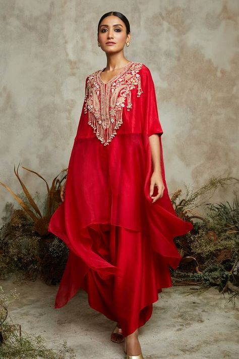 Blood red asymmetric kaftan with paisley, floral embroidery using dori, multi threads and pearl tassel work. Paired with asymmetric pant. - Aza Fashions Kaftan Indian Style, Aza Fashion Outfits, Asymmetrical Kurti, Goa Dress, Asymmetric Pants, August Outfits, Indian Dresses For Women, Organza Embroidery, Kaftan Designs