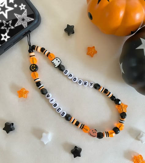 ♡ Halloween Spooky Vibes Phone Charm/Strap ♡ Approximately 7 1/2 inches in length from top of cord to bottom of beads ♡Made with: * black waxed cord  * acrylic beads * polymer clay beads ♡ PHONE CHARM CARE:  * Please note all of our phone charms are meant to be used as an accessory and not meant to hold your phone * Excessive pulling on phone charm may cause breakage * We are not responsible for any charms that break once they are in your care ♡ Beads and bead colors may vary but will look very similar to the phone charm pictured ♡ Please contact me if you have any questions or any bead color preferences DISCLAIMER:  * All of our phone charms are not intended for small children  * Beads are a choking hazard for children * BestieBeadz assumes no responsibility Fall Phone Charm Ideas, Fall Phone Charms, Halloween Phone Charm Ideas, Clay Bead Phone Charm Ideas Preppy, Clay Bead Phone Strap, Halloween Phone Charm, Phone Charm Ideas Clay Beads, Spooky Bracelet Ideas, Halloween Stuff To Do