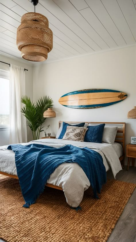 Ride the wave of style with this boho coastal bedroom featuring a vintage surfboard as art. Get inspired by the perfect blend of beach and bohemian! #SurfboardDecor #VintageBoho Surfer Style Bedroom, Beach Themed Airbnb, Surf Board Bedroom, Surfer Bedroom Ideas Boys, Vintage Surfer Room, Surfboard Above Bed, Surfer Room Ideas, Boys Surf Bedroom, Boho Surf Bedroom