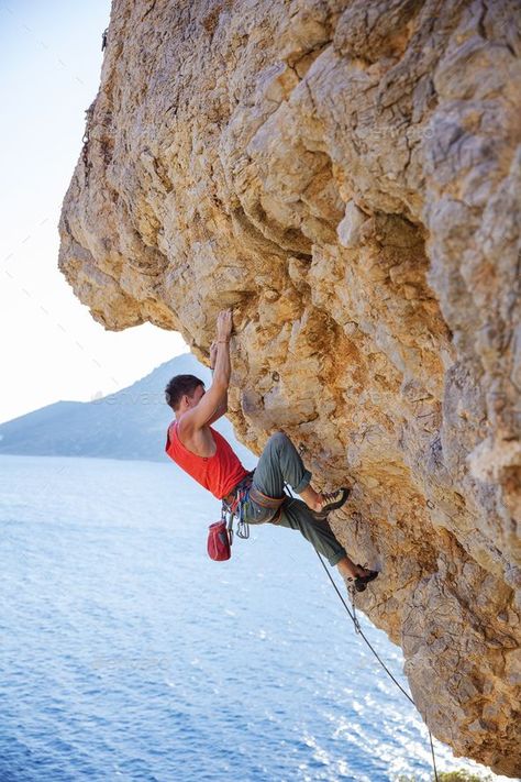 Young man lead climbing on overhanging cliff by photobac. Young man lead climbing on overhanging cliff over water #Affiliate #lead, #climbing, #Young, #man Rock Climbing Workout Beginner, Rock Climbing Photography, Kids Rock Climbing, Rock Climbing Outfit, Rock Climbing Workout, Climbing Wall Kids, Free Climb, Lead Climbing, Rock Climbing Gym