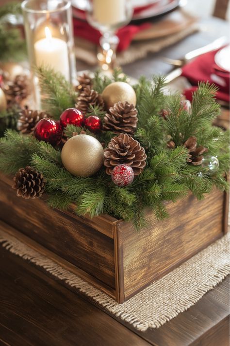 Bring a touch of the French countryside to your holiday table with a rustic wooden box centerpiece. Filled with white candles, pine branches, and a dusting of faux snow, it’s a timeless look that adds farmhouse warmth to any setting. Use floral foam to keep everything in place. This is one of my favorite ways to create a cozy, French-inspired Christmas centerpiece! Wooden Box Table Centerpiece, Table Box Centerpiece, Rustic Wooden Box Centerpiece, Wooden Box Centerpiece, Box Centerpiece, Rustic Wooden Box, French Country Christmas, French Christmas, Faux Snow