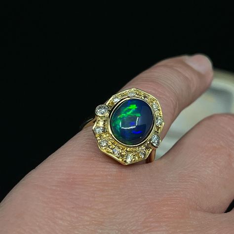 We love this solid Opal ring, if anything it has a bit of an air of 1980’s spunk 😁 The oval solid Opal originates from Ethiopia and its bezel set within an Etruscan reminiscent boarder in 18K yellow gold, set with 12 round brilliant cut Diamonds which are graded in the setting, G to light Champagne. We know how we feel about Champagne Diamonds 🫠🥂 This Opal is dominantly azure blue with flashes of apple green and carnelian. 👌🏽we love it. This ring is now reduced half price making it totally... Azure Blue, Half Price, Champagne Diamond, Apple Green, Opal Ring, Gold Set, Round Brilliant Cut Diamond, Opal Rings, Round Brilliant Cut