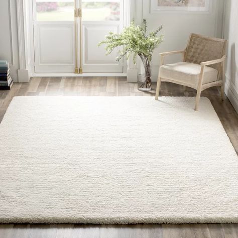 Set an approachable and on-trend foundation in your home with this shag rug. It features an understated and neutral ivory hue that sets the scene for any color palette in your living room or bedroom. Handmade in India from polyester with a cotton backing, this area rug has a long 1.57" pile height for a shag look. We recommend rolling out a rug pad underneath this design to keep it safely in place and prevent slipping and sliding.Hand-curated by Kelly Clarkson. Area Rug Sets, Solid Color Rug, Cheap Rugs, Ivory Area Rug, Kelly Clarkson, Shag Area Rug, Silver Area Rug, Rug Sets, Handmade Area Rugs