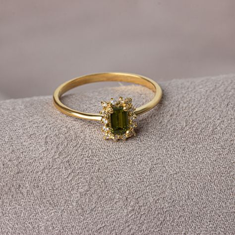 With its shimmering pale green color, peridot stone is also known as the "evening emerald". It is a gemstone often associated with spirituality and expression. Our rectangular peridot stone ring surrounded by real diamonds will add elegance to your hands. It is a ring that you can use both on special occasions and in daily life. It is a beautiful and stylish product that you can gift to yourself and your loved ones. The color of those born in August is Peridot. Our necklace compatible with our r Peridot And Gold Ring, Vintage Green Rings, Virgo Engagement Ring, Engagement Rings Gold Colored Stone, Peridot And Diamond Engagement Rings, Elegant Birthstone Rings For Party, Elegant Party Rings With Birthstone, Fine Jewelry Green Emerald Ring For Party, Gold Rectangular Emerald Ring For May Birthstone