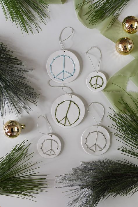 Learn how to make Clay Peace Sign Ornaments using polymer clay and colorful embroidery floss! This fun craft project gives new life to simple clay ornaments with trendy peace signs used in a modern new way. Delineate Your Dwelling Needle Threaders, How To Make Clay, Christmas Clay, Colorful Embroidery, Sewing Scissors, Needle Threader, Peace Signs, Clay Ornaments, Fun Craft