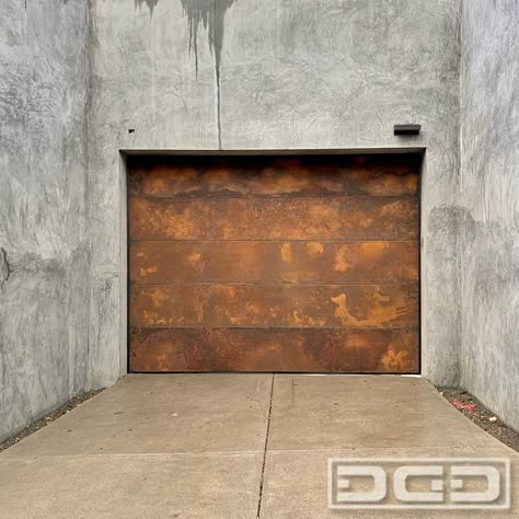 Achieve the look and feel of a true industrial architectural style home with a Cor-ten Steel Garage Door! This fabulous garage door was ingeniously used to accentuate the exterior of this museum quality industrial home in California.  The garage door consists of flush Cor-ten Steel panels that were beautifully pre-corroded to speed up the corrosion process that would normally take a few years. Corten Garage Door, Retro Garage Door, Bronze Garage Doors, Garage Door Murals, Industrial Garage Door, Modern Garage Door, Steel Garage Door, Garage Door Designs, Unique Garage Doors